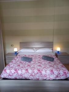 a bedroom with a large bed with two pillows on it at Apartment L'aquila in LʼAquila