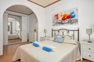 a bedroom with two beds with towels on them at Villa Son Esbert by Villa Plus in Alaior +18 photos