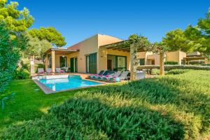 a house with a swimming pool in a yard at Villa Josefa by Villa Plus in Cala Galdana