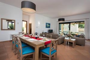 a dining room and living room with a table and chairs at Villa Josefa by Villa Plus in Cala Galdana