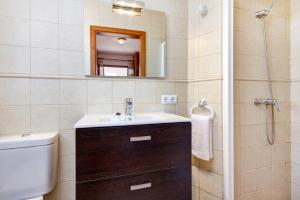 a bathroom with a sink and a toilet and a mirror at Villa Casa Blanca by Villa Plus in Cala Blanca +16 photos