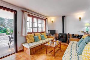 a living room with a couch and a fireplace at Villa Can Idu by Villa Plus in El Port