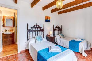 a room with two beds and a sink at Villa Can Idu by Villa Plus in El Port +10 photos