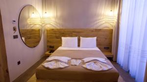 a bedroom with a bed with two towels on it at Dmira Alacati in Alaçatı