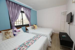 Voodi või voodid majutusasutuse 小葉園民宿Little Ya B&B toas