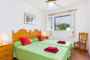 a bedroom with two beds and a window at Villa Blanc Arenal by Villa Plus in Es Mercadal +16 photos
