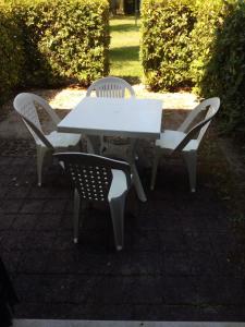 a white picnic table and chairs on a patio at Cozy Silvia in SantʼAndrea Apostolo dello Ionio