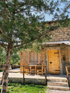 a picnic table in front of a stone building at Hovek Guest House in Dilijan