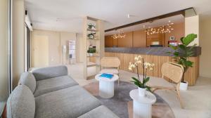 a living room with a couch and tables and chairs at Apartments Bellevue Plava Laguna in Poreč