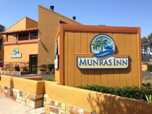 a large building with a sign on the side of it at Munras Inn in Monterey