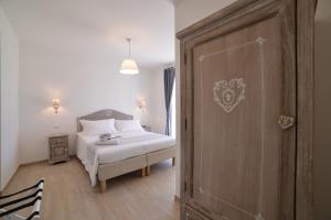 a bedroom with a bed and a wooden door at il Lago di Nemi in Nemi