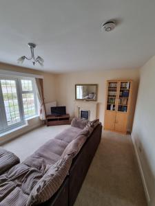 a large bedroom with a large bed and a fireplace at Lovely 2-Bedroom New Forest apartment on a Farm in New Milton