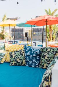 a blue couch with a blue umbrella on top of it at Mama Shelter Los Angeles in Los Angeles