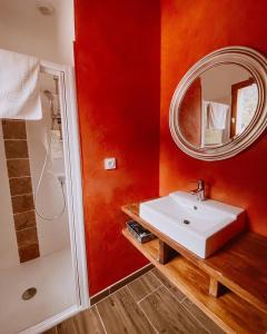 a bathroom with a white sink and a mirror at Auberge De La Foret Bonifatu in Calenzana