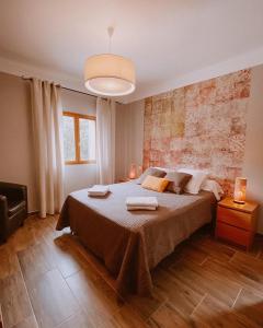 a bedroom with a large bed with two towels on it at Auberge De La Foret Bonifatu in Calenzana