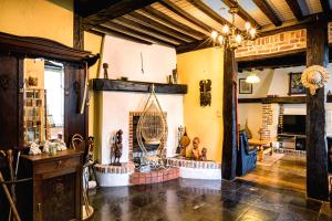 a living room with a fireplace in a house at Relax à Maison Sax Kingsize in Durbuy