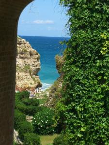 a view of the ocean through an archway at Casa Marianna Short Lets in Polignano a Mare