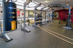 a gym with a lot of equipment in it at Hotel De Bonte Wever Assen in Assen