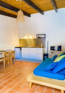 a bedroom with a bed and a kitchen with a table at Auberge De La Foret Bonifatu in Calenzana +30 photos