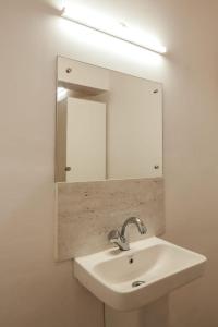 a bathroom with a sink and a mirror at The Nirvana Resort Munnar in Munnar