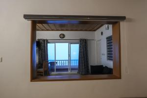 a mirror on a wall with a view of a room at The Nirvana Resort Munnar in Munnar