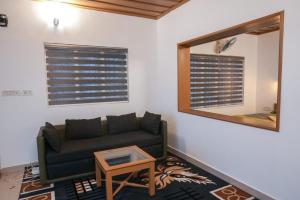 a living room with a couch and a mirror at The Nirvana Resort Munnar in Munnar