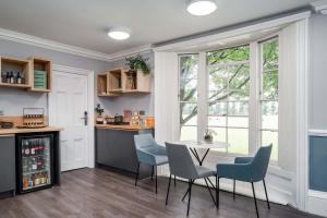 a kitchen with a table and chairs and a window at The Regent in Cambridge