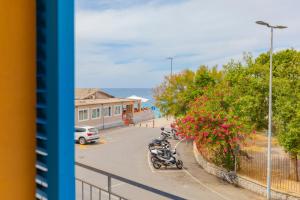 a group of motorcycles parked in a parking lot at HelloElba Le Ghiaie Beach in Portoferraio