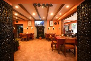 a restaurant with tables and chairs in a room at Sacred Boutique Hotel in Kathmandu