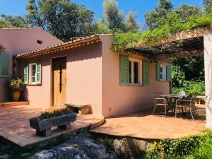 a small house with a patio and a table at Villa Font March in Pollença