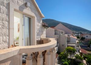 a balcony with a view of a city at Hektorovic poolside apartments in Bol