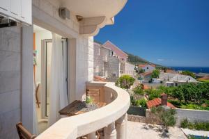a balcony with a view of a city at Hektorovic poolside apartments in Bol