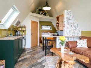 a kitchen and a living room with a couch and a table at Buttercup Lodge in Doncaster
