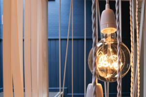 a light bulb hanging from a string in a room at Mon P'tit Hôtel in Le Grau-dʼAgde