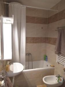 a bathroom with a sink and a tub and a toilet at Itaka - Belgrade City Center in Belgrade +27 photos