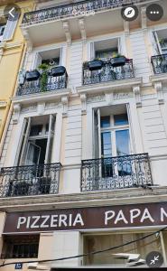 a building with balconies and a sign on it at 2 Bedroom luxury flat Cannes Center La Croisette in Cannes