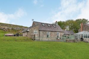 an old stone house with a green yard at Hafan Haydn in Cwm