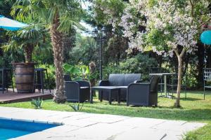 a group of chairs sitting next to a pool at Camping car Canal du Midi in Montesquieu-Lauragais