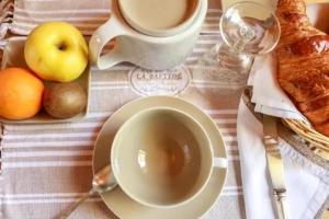 a table with a cup of coffee and a plate of fruit at Camping car Canal du Midi in Montesquieu-Lauragais