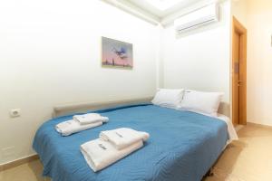 A bed or beds in a room at Eleni Luxury Maisonette with Jacuzzi