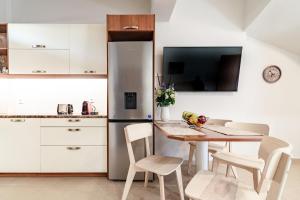 A kitchen or kitchenette at Eleni Luxury Maisonette with Jacuzzi