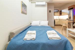 A bed or beds in a room at Eleni Luxury Maisonette with Jacuzzi