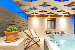 The swimming pool at or close to Eleni Luxury Maisonette with Jacuzzi
