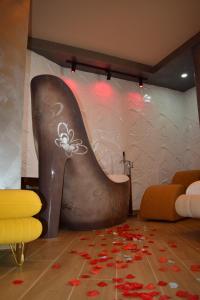 a room with a wall with a painting of a tall boot at Vila One Beach Hotel in Durrës