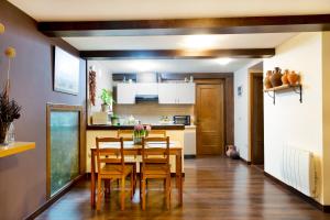 a dining room and kitchen with a table and chairs at El Rencuentro Casa Rural de Gredos in Villarejo del Valle