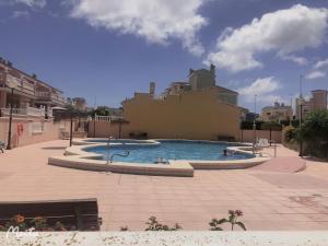 a large swimming pool in a courtyard with buildings at STARRY SKY in Santa Pola