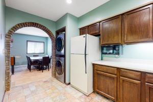 a kitchen with a refrigerator and a dining room at Smoky Mountain Castle Caretaker's Apartment in Sevierville