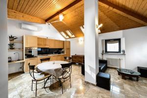 a kitchen and dining room with a table and chairs at Faber Apartments-Residence Style in Arona