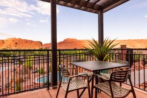 a table and chairs on a balcony with a view of the canyon at Hyatt Place Moab in Moab