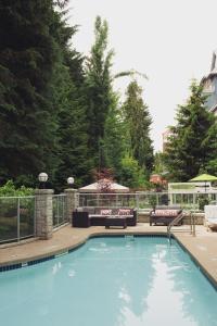 a pool with a pool table and chairs in it at Summit Lodge Boutique Hotel Whistler in Whistler